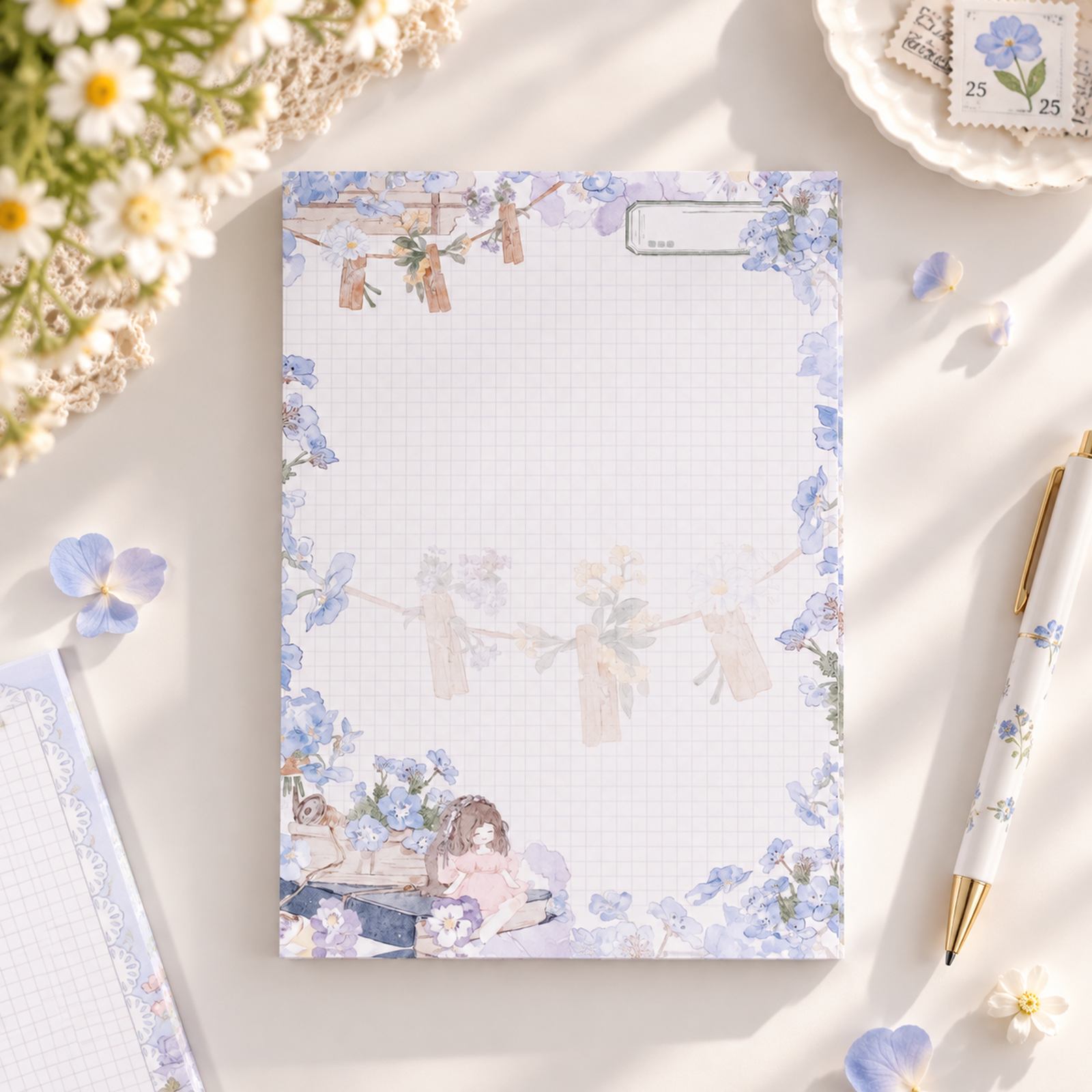 Blooming Days A5 grid notepad with blue floral watercolour border and illustrated details