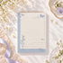 Bloc-notes A6 Petal Postmark avec fleurs bleues et motifs postaux vintage