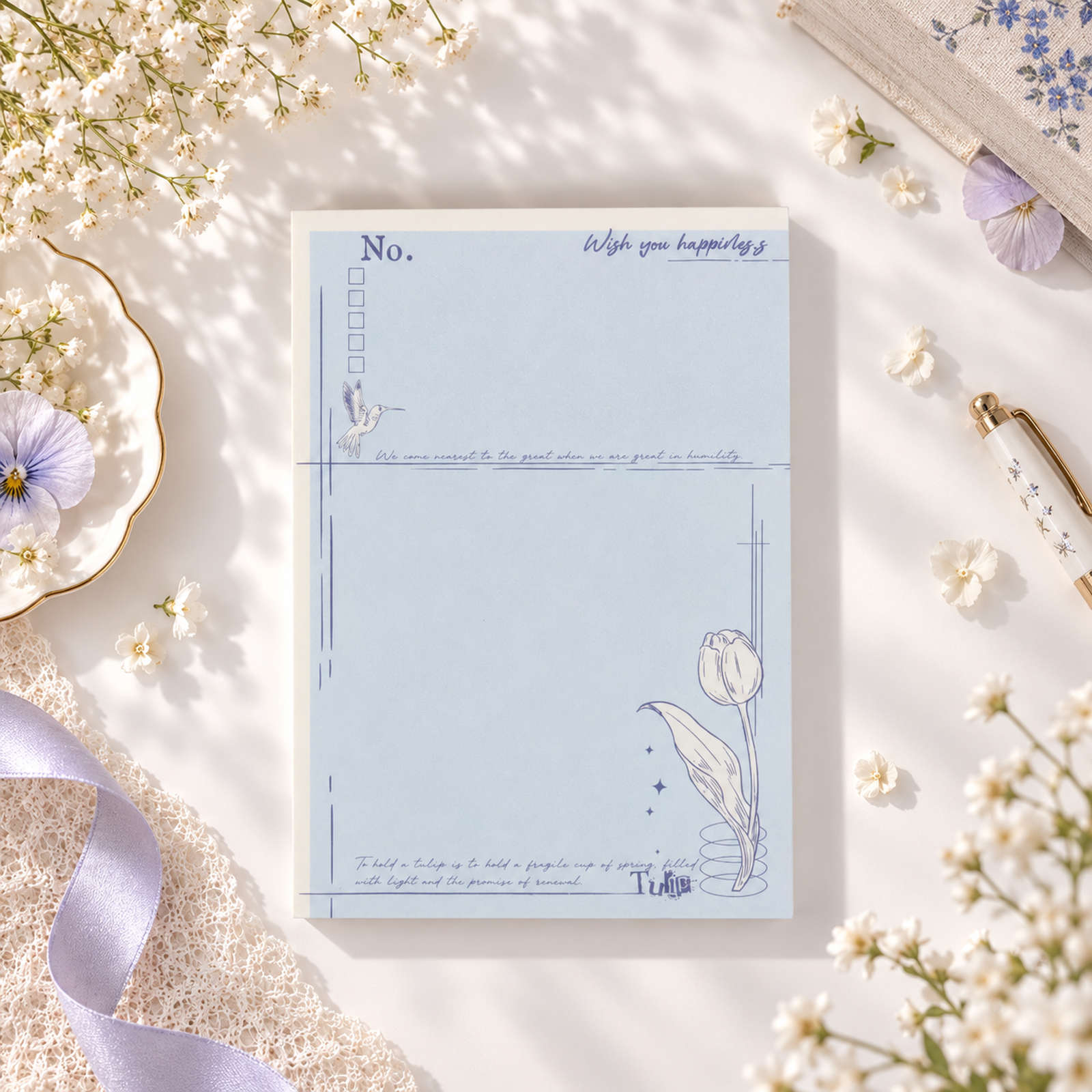 Tulip Notes A6 notepad with blue floral details and lined writing layout