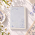 Forest of Blue Mist A6 notepad with purple botanical border and lined layout