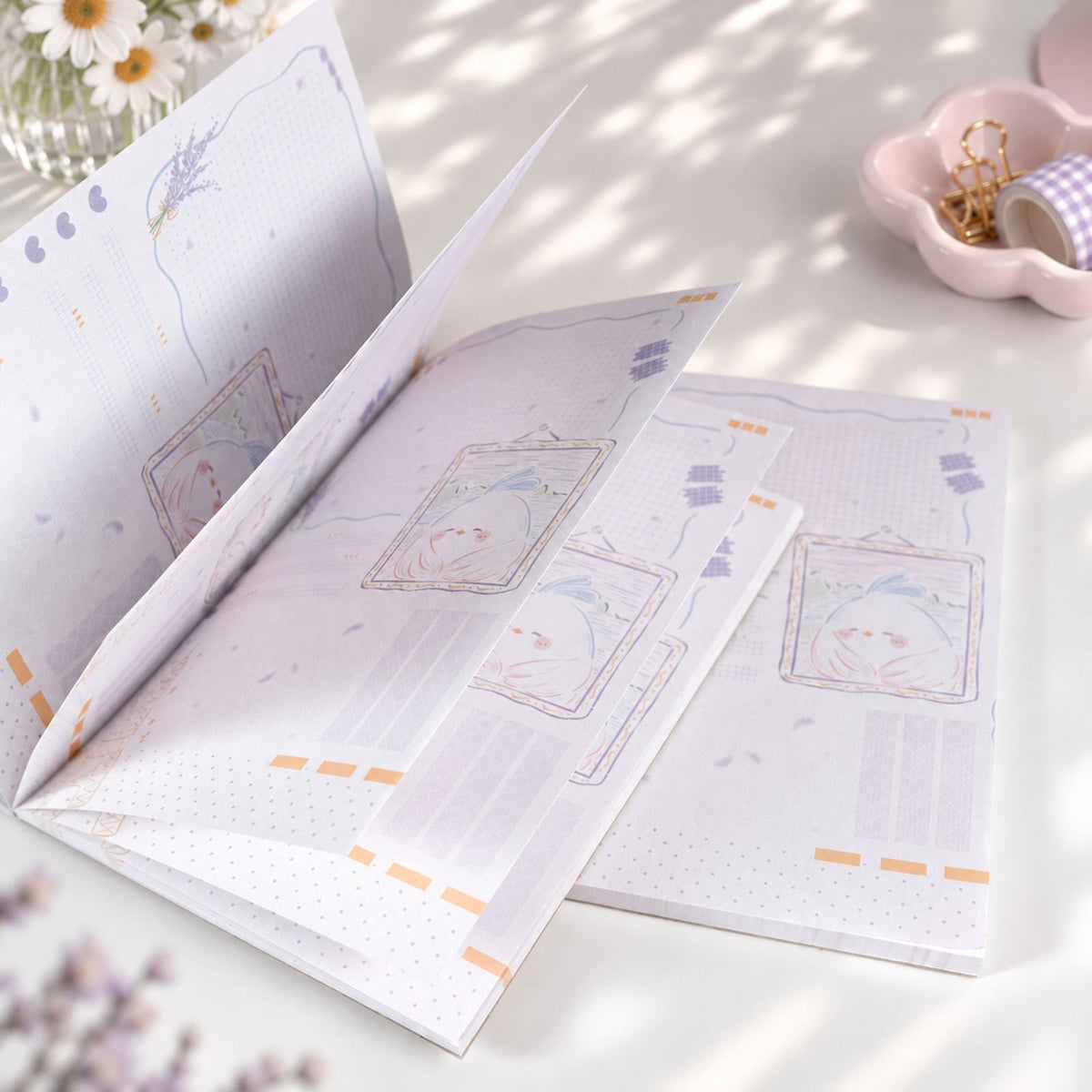 Little Chirp A6 notepad open pages with double-sided illustrated design