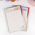 Flat lay of Vintage Train Postage Notepad showing A5 size, lined layout, and vintage travel-inspired artwork - Miouva